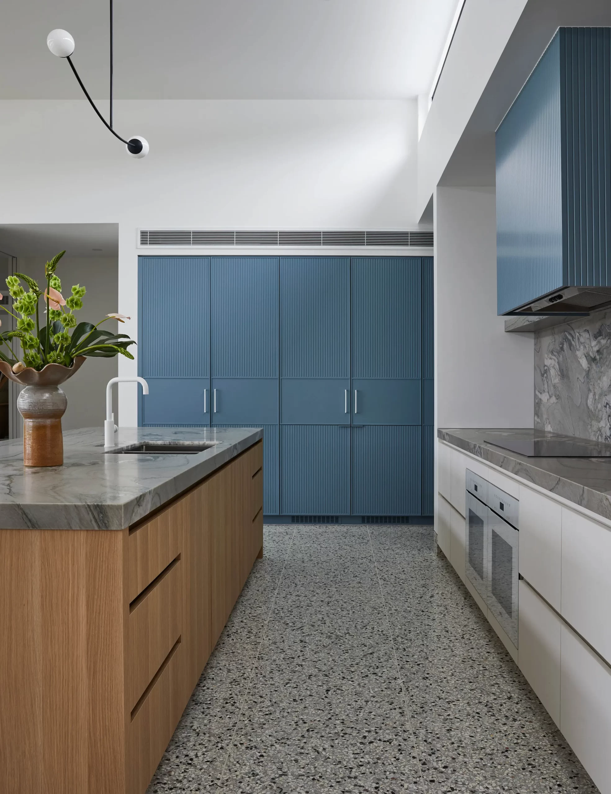 Mid century modern kitchen blue and white, terrazzo flooring