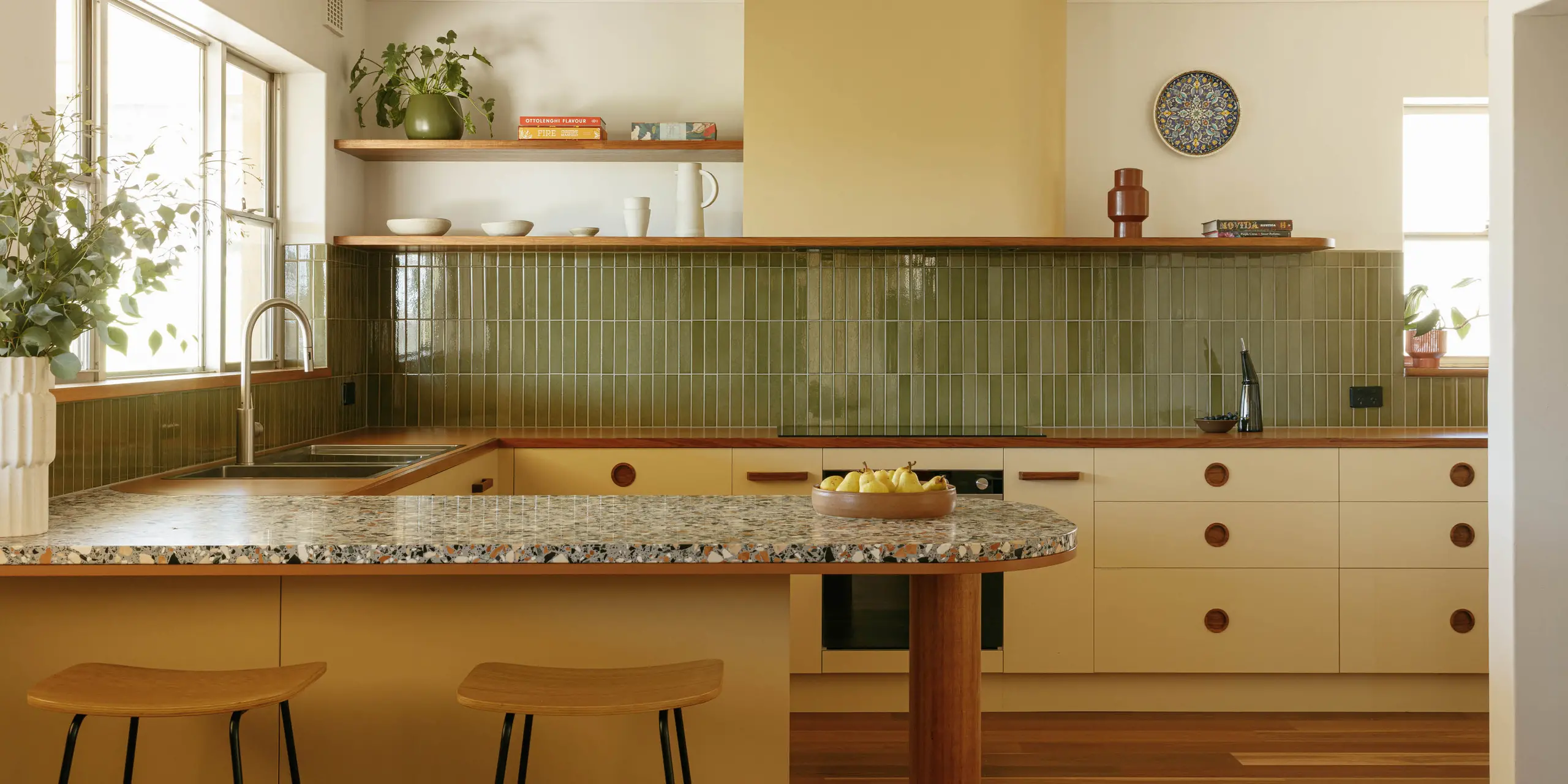 Cream mid century modern kitchen with terrazzo countertop and green tiles backsplash mid century modern pulls 